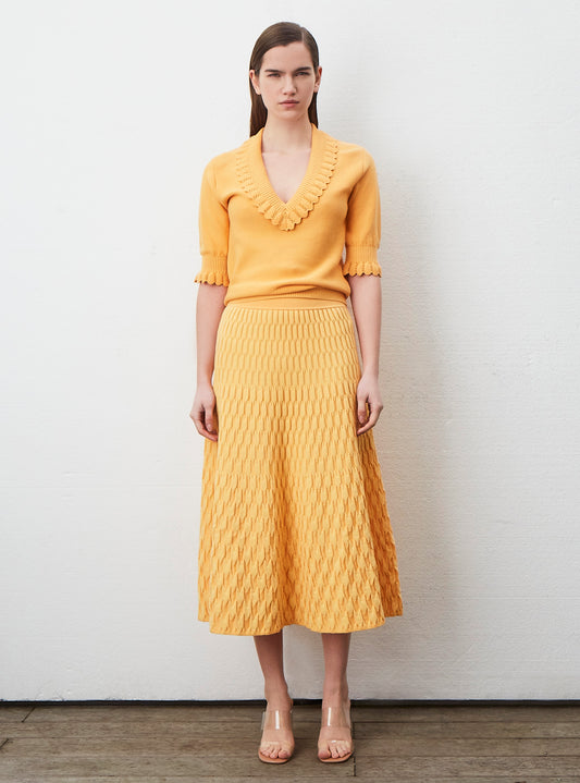 top with ruffled v-neckline and elbow-length sleeve